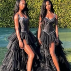 Diddy’s twin daughters, D’Lila and Jessie Combs, match at prom in black bedazzled bustier gowns
