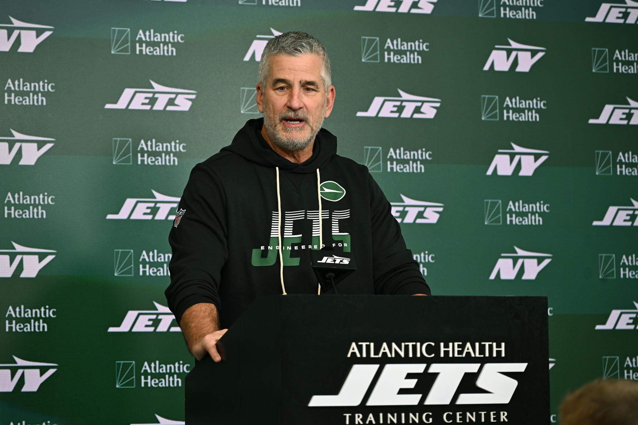 New York Jets offensive coordinator Frank Reich speaks at a press conference.