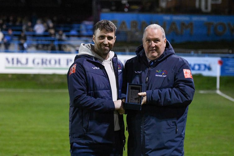 Farnham Town manager Paul Johnson (left) receives the February PST Sport Club of the Month award from Southern League chairman David Martin