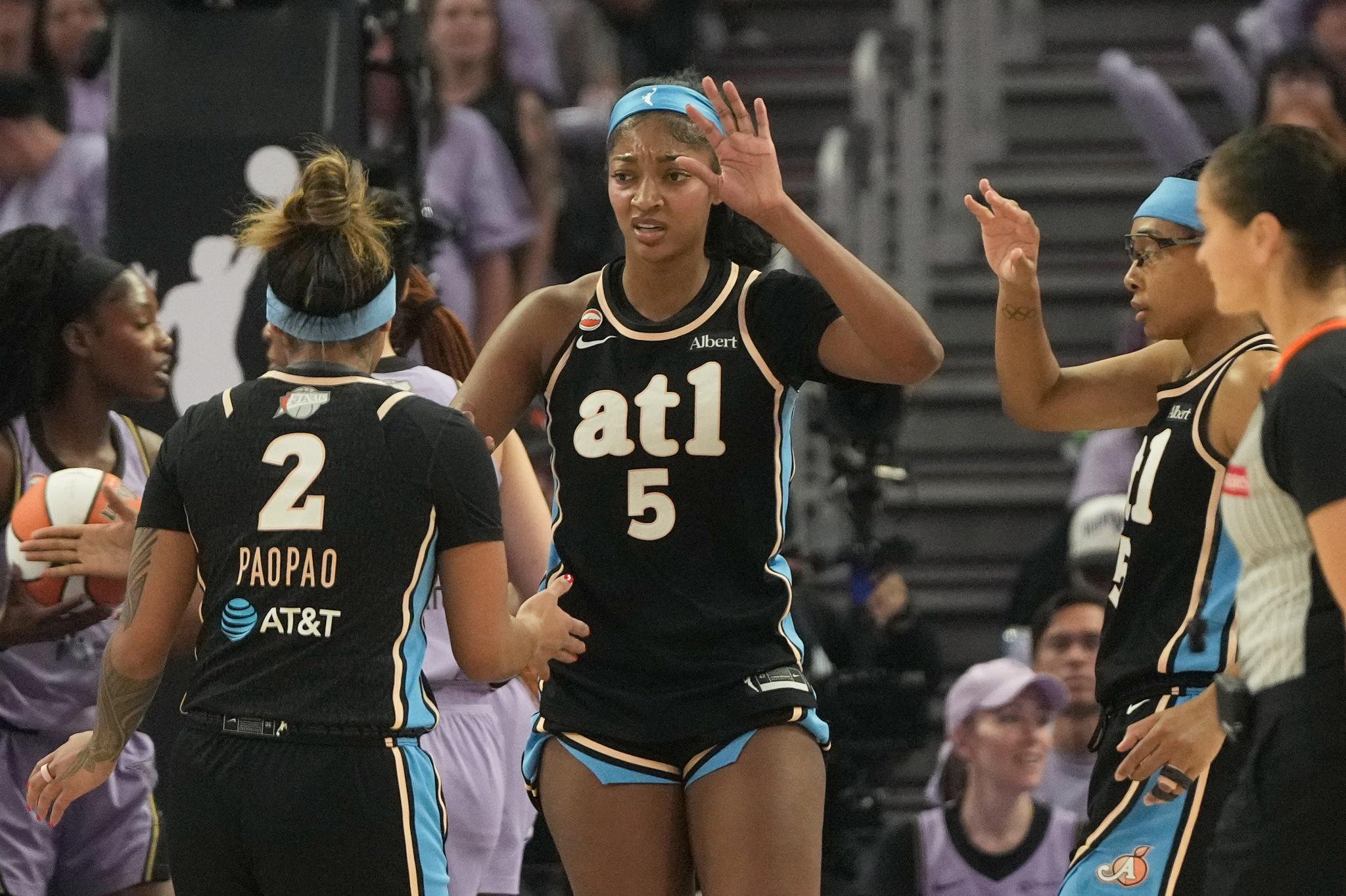 Angel Reese, Te-Hina Paopao, and Allisha Gray playing basketball.