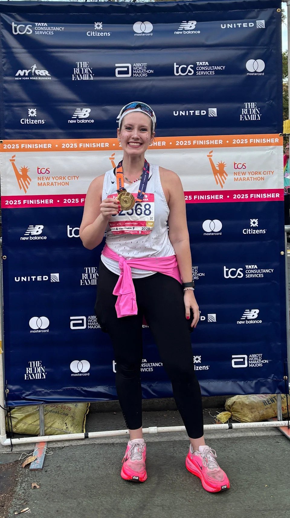 Halie LeSavage at the 2025 New York City Marathon finish line wearing full makeup