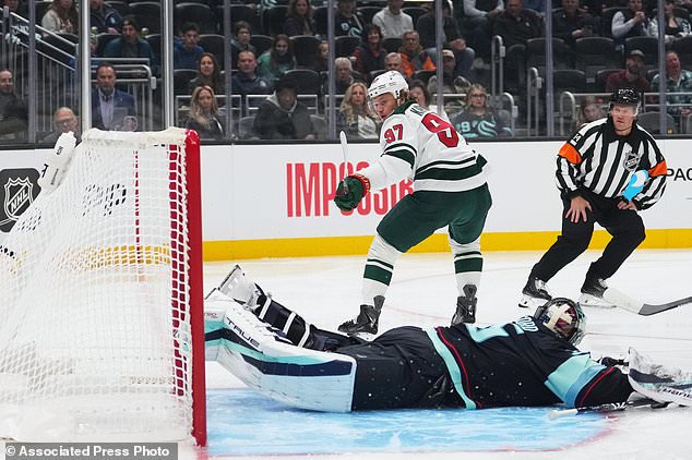 Minnesota Wild left wing Kirill Kaprizov (97) scores a goal against Seattle Kraken goaltender Joey Daccord (35) during the first period of an NHL hockey game Saturday, Oct. 24, 2026, in Seattle. (AP Photo/Lindsey Wasson)