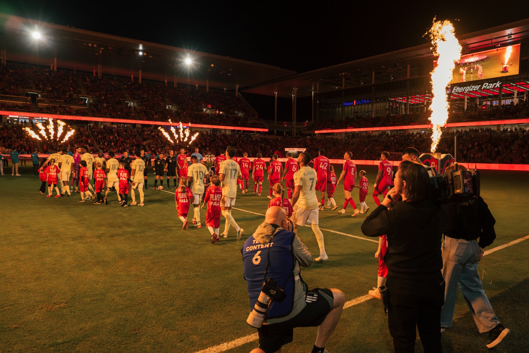 St. Louis City SC and Portland Timbers players take the field alongside youth soccer players as pyrotechnics erupt before their match on Wednesday, Oct. 28, 2026, at Energizer Park in St. Louis’ Downtown West neighborhood.