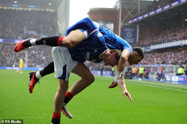 Rangers´ Kevin Kelsy, right, celebrates opening the scoring (PA)