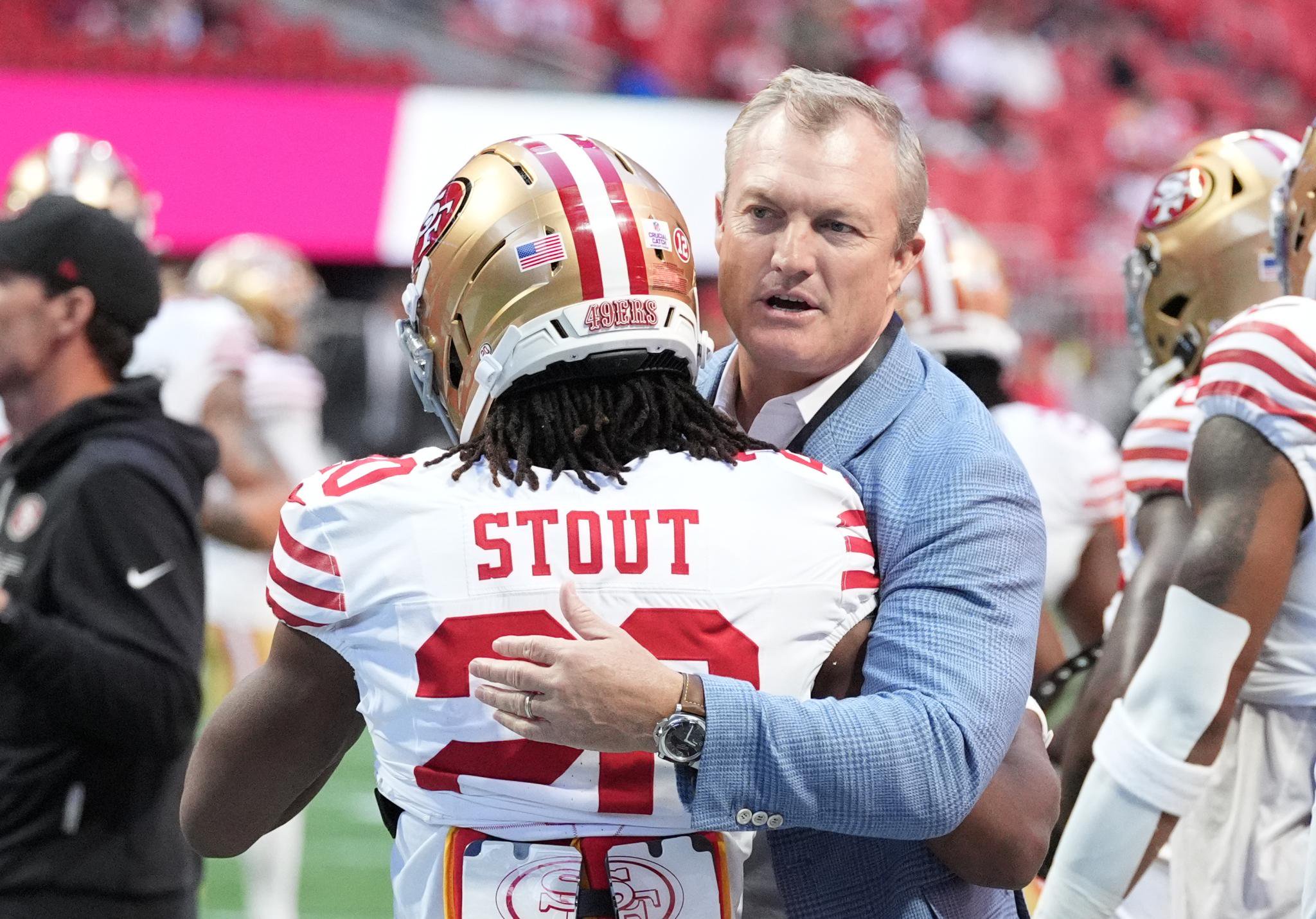 San Francisco 49ers general manager John Lynch hugs cornerback Upton Stout before a game.
