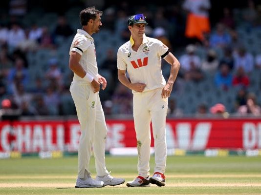 Australia fast bowlers Mitchell Starc and Pat Cummins chat on the final day of the third Ashes cricket Test match between Australia and England at the Adelaide Oval