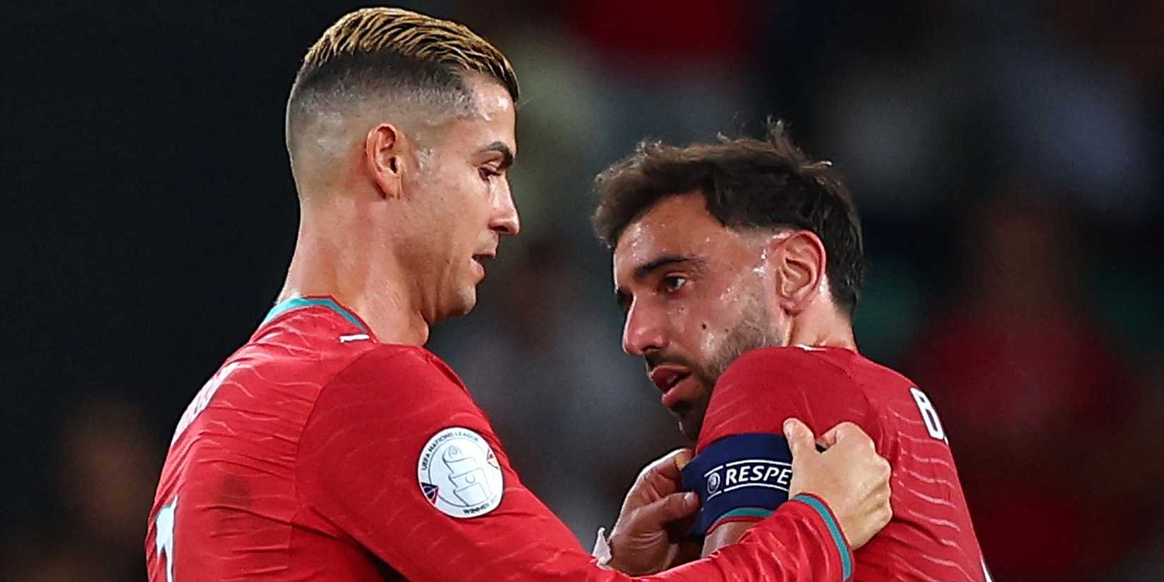 Cristiano Ronaldo putting the Captains armband around the arm of his teammate Bruno Fernandes