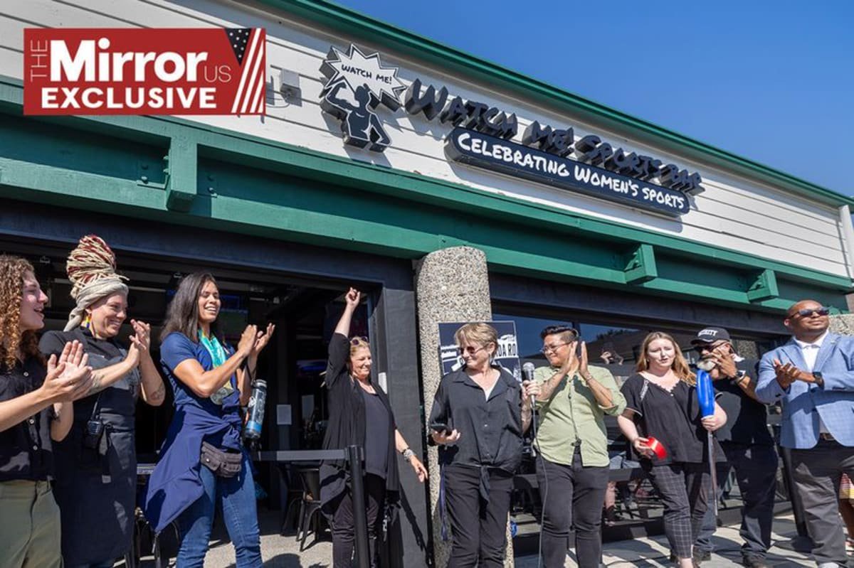 Co-owners Emme Eddy, center, with hand up, and Jax Diener, right center, of the women's sports bar Watch Me! Sports Bar in Long Beach, celebrate with founders, supporters and patrons during the grand opening ceremony Friday, July 26, 2024