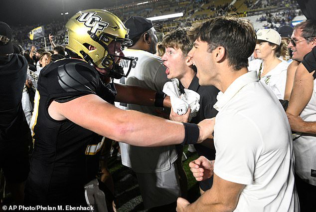 UCF snapper Rocklyn Kelley, left, celebrates with fans after an upset win over BYU last week