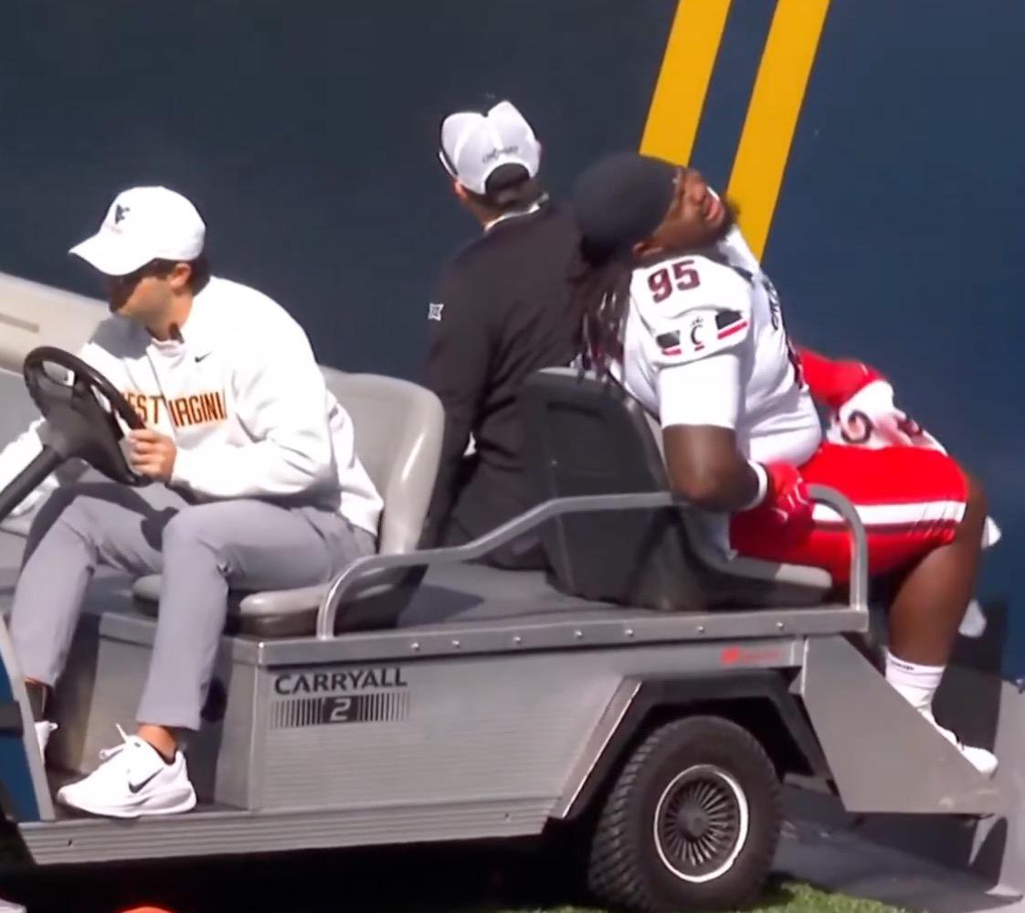 Cincinnati defensive tackle Josh Hough is carted off with an injury during a game against West Virginia.