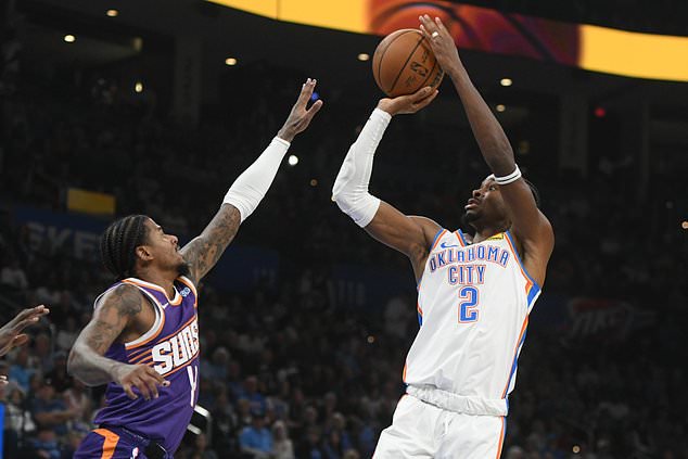Oklahoma City Thunder guard Shai Gilgeous-Alexander, right, looks to shoot over Phoenix Suns guard Jalen Green, left, during the second half of an NBA basketball game, Monday, Oct. 26, 2026, in Oklahoma City. (AP Photo/Kyle Phillips)