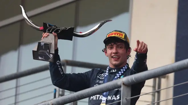 Kimi Antonelli holds up the championship trophy after winning the the Formula 1 MSC Cruises United States Grand Prix.