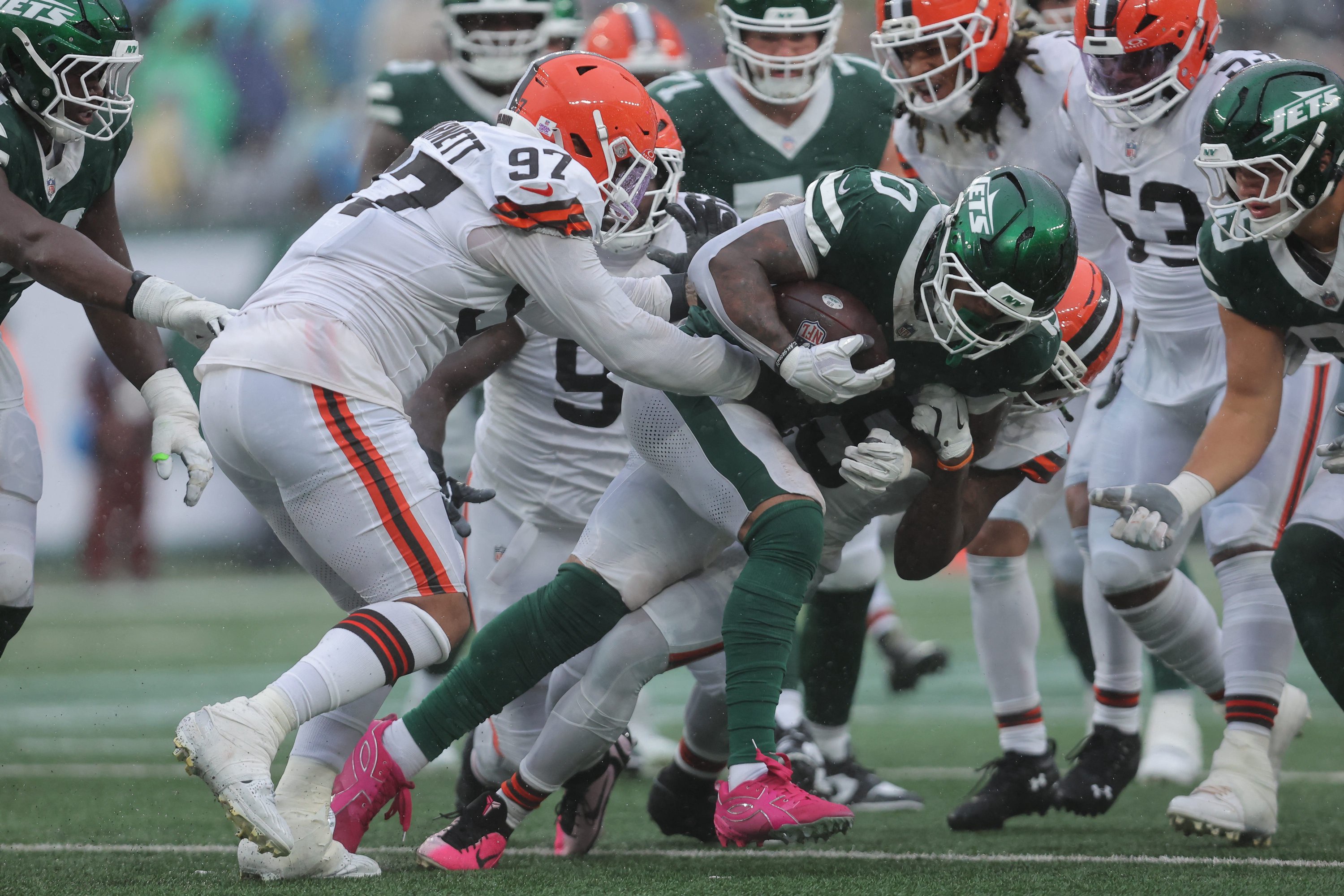 Oct 11, 2026; East Rutherford, New Jersey, USA;  Cleveland Browns wide receiver Isaiah Bond (0) is tackled by Cleveland Browns linebacker Quincy Williams (5) and defensive end Derek Barnett (97) during the second half at MetLife Stadium.  Mandatory Credit: Brad Penner-Imagn Images
