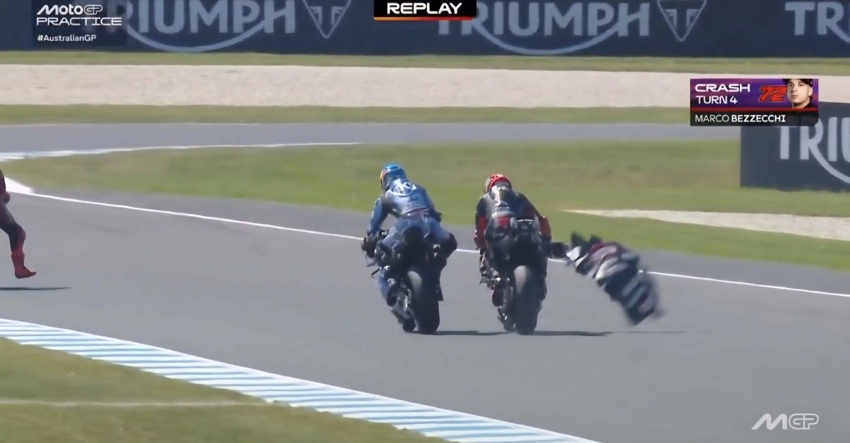 MotoGP replay showing a crash at Turn 4 during the Australian GP, with a rider in red leathers sliding off his bike beside another rider in blue on the track.