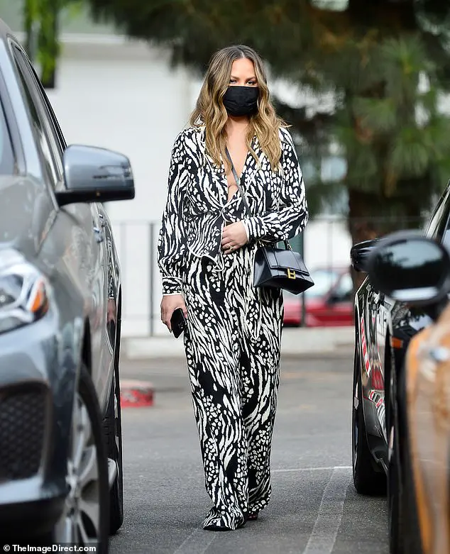 Errands: Chrissy Teigen looked great as she stepped out in LA on Thursday wearing a stylish blouse and pants set