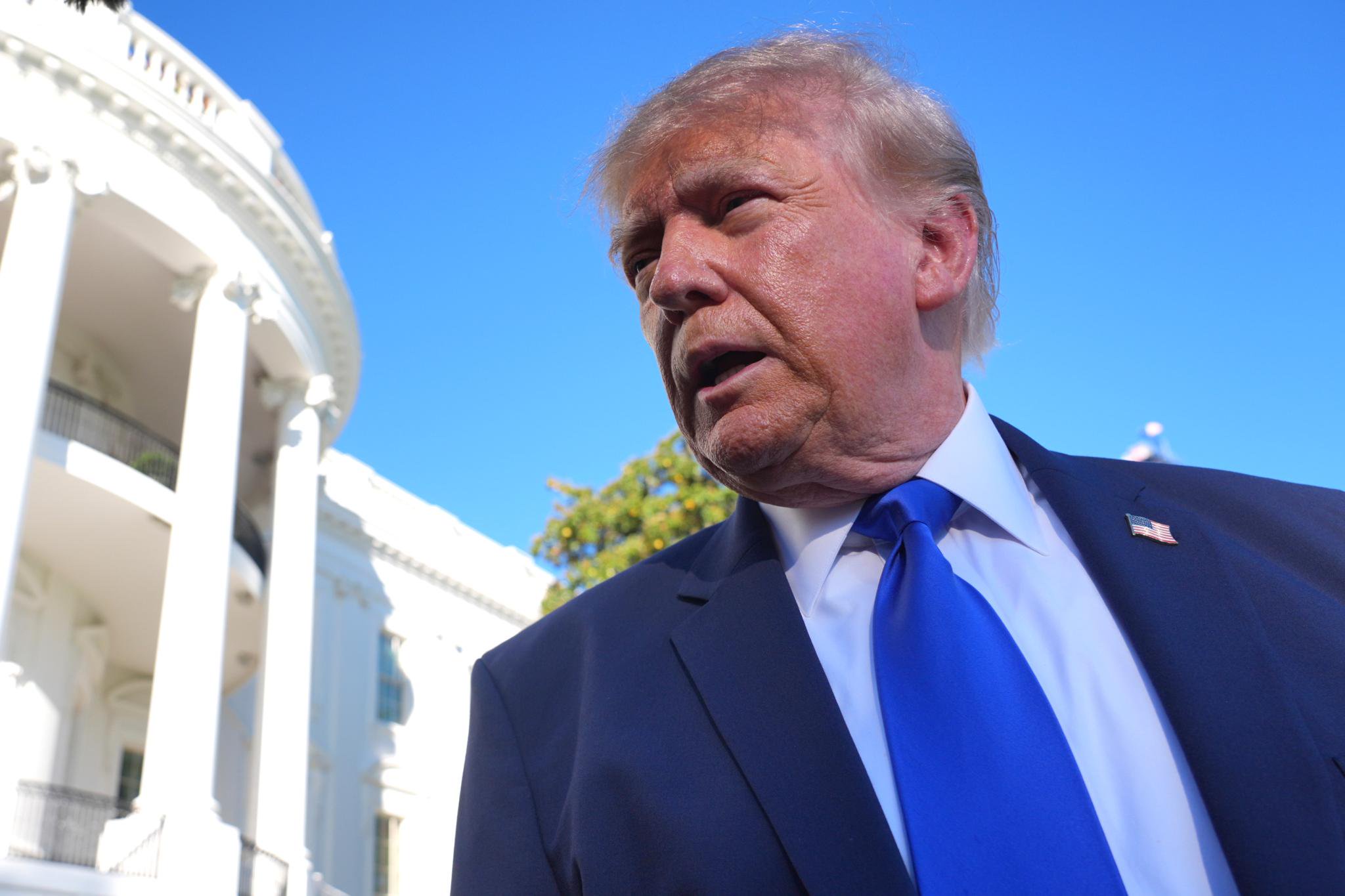 President Donald Trump speaks to reporters in Washington.