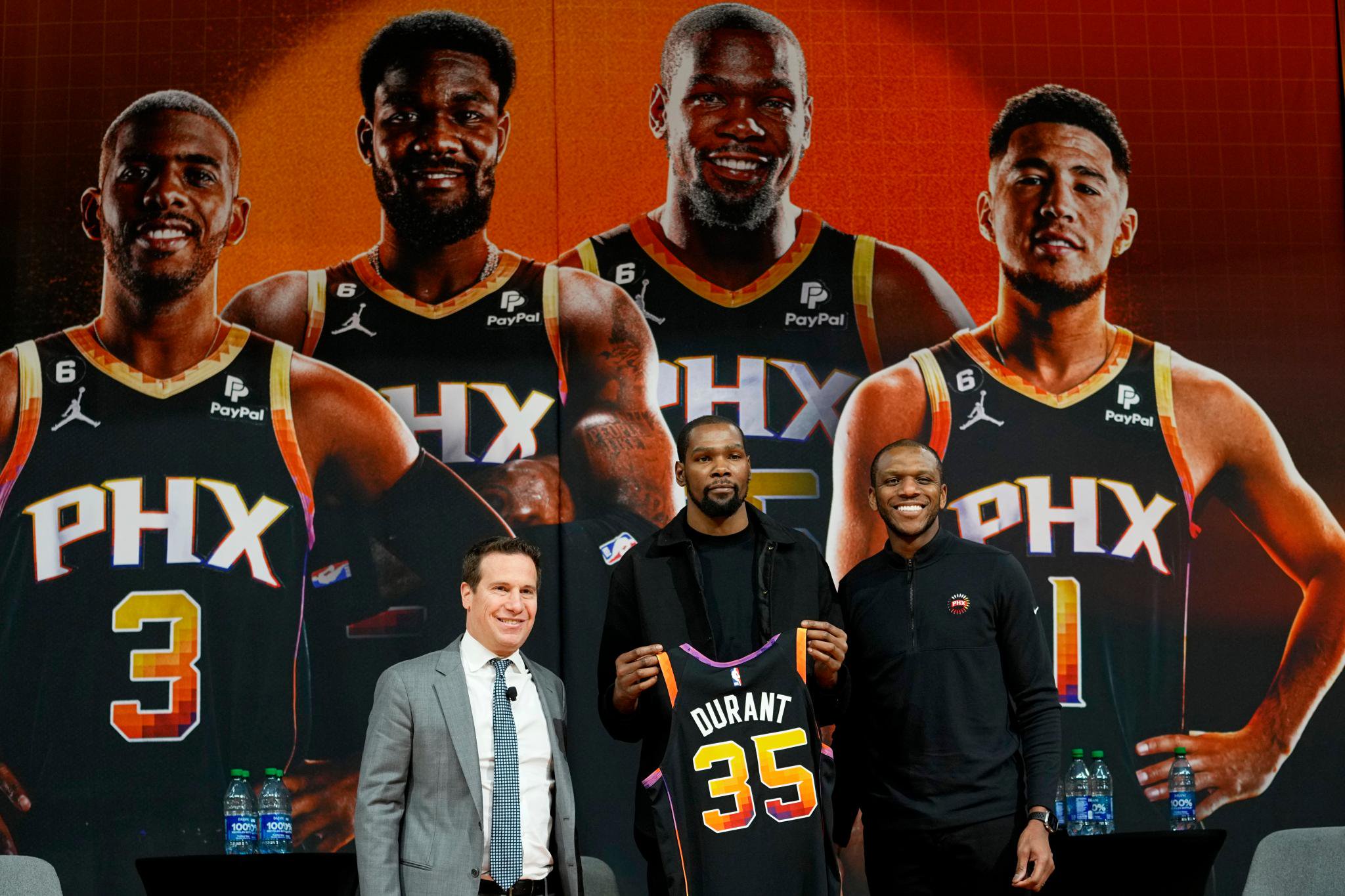 Phoenix Suns forward Kevin Durant holds his jersey after being introduced by owner Mat Ishbia and general manager James Jones.