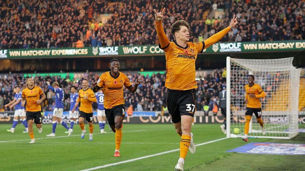 Ladislav Krejci celebrates with his arms in the air after scoring for Wolves