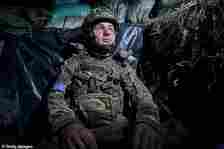 A soldier rests as Infantry secure the area for the 3rd Assault Brigade at sunset on July 1, 2024 in Kharkiv Region