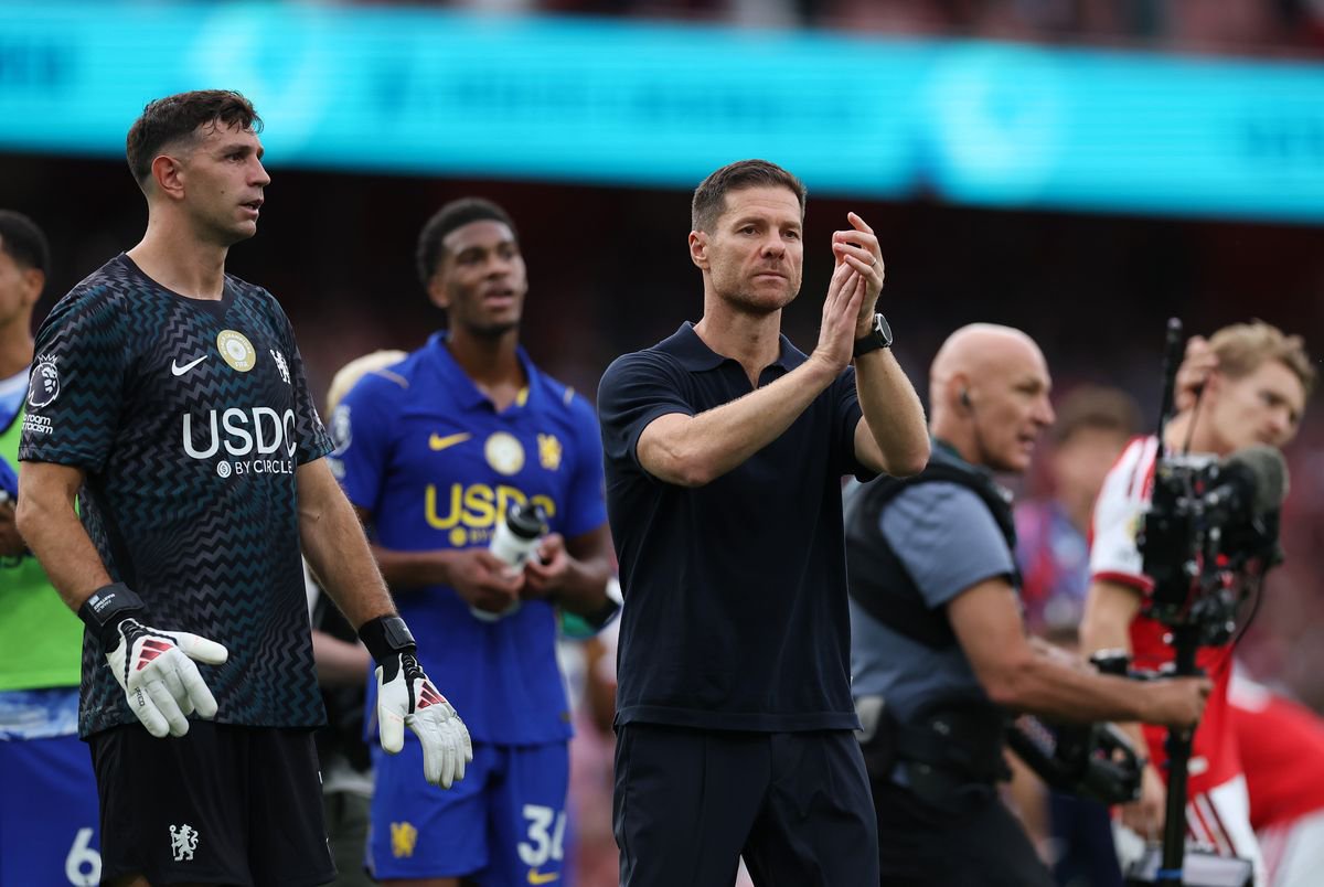 Xabi Alonso applauds the Chelsea supporters following the defeat at Arsenal