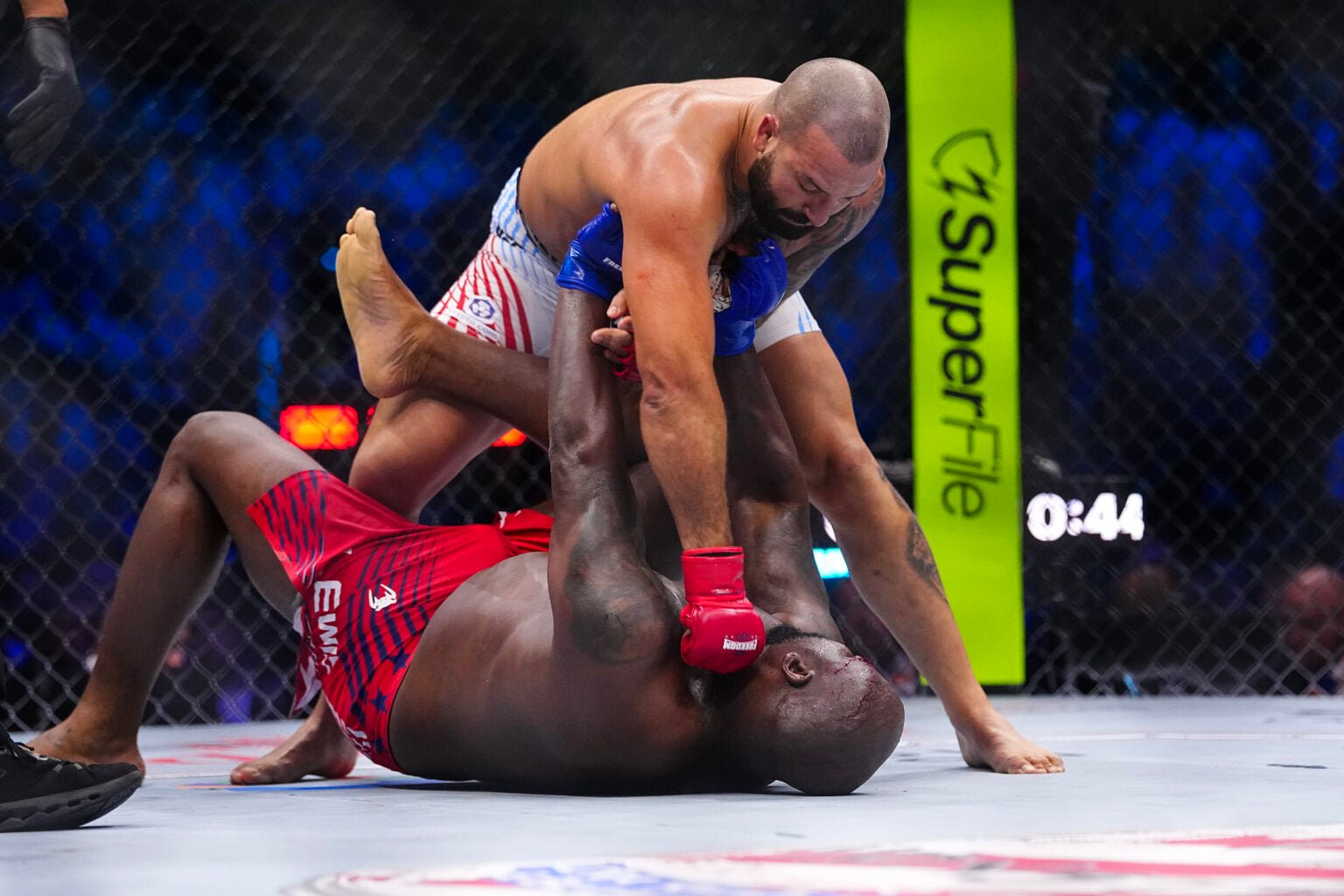 Josh Hokit punches Derrick Lewis on the ground at UFC Freedom 250