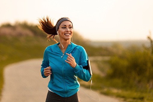 Happy Female Runner Jogging In The Morning In Nature Stock Photo - Download Image Now - iStock