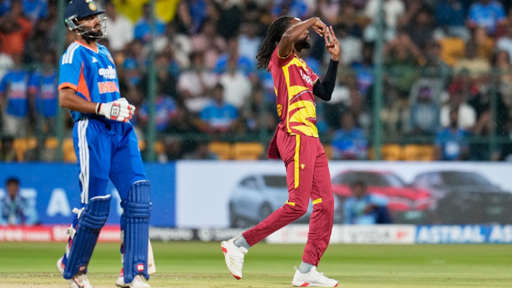 West Indies' Shamar Springer, right, celebrates the dismissal of India's Tilak Varma during the fifth T20 cricket match between India and West Indies in Bengaluru, India, Saturday, Oct. 17, 2026. (AP Photo)
