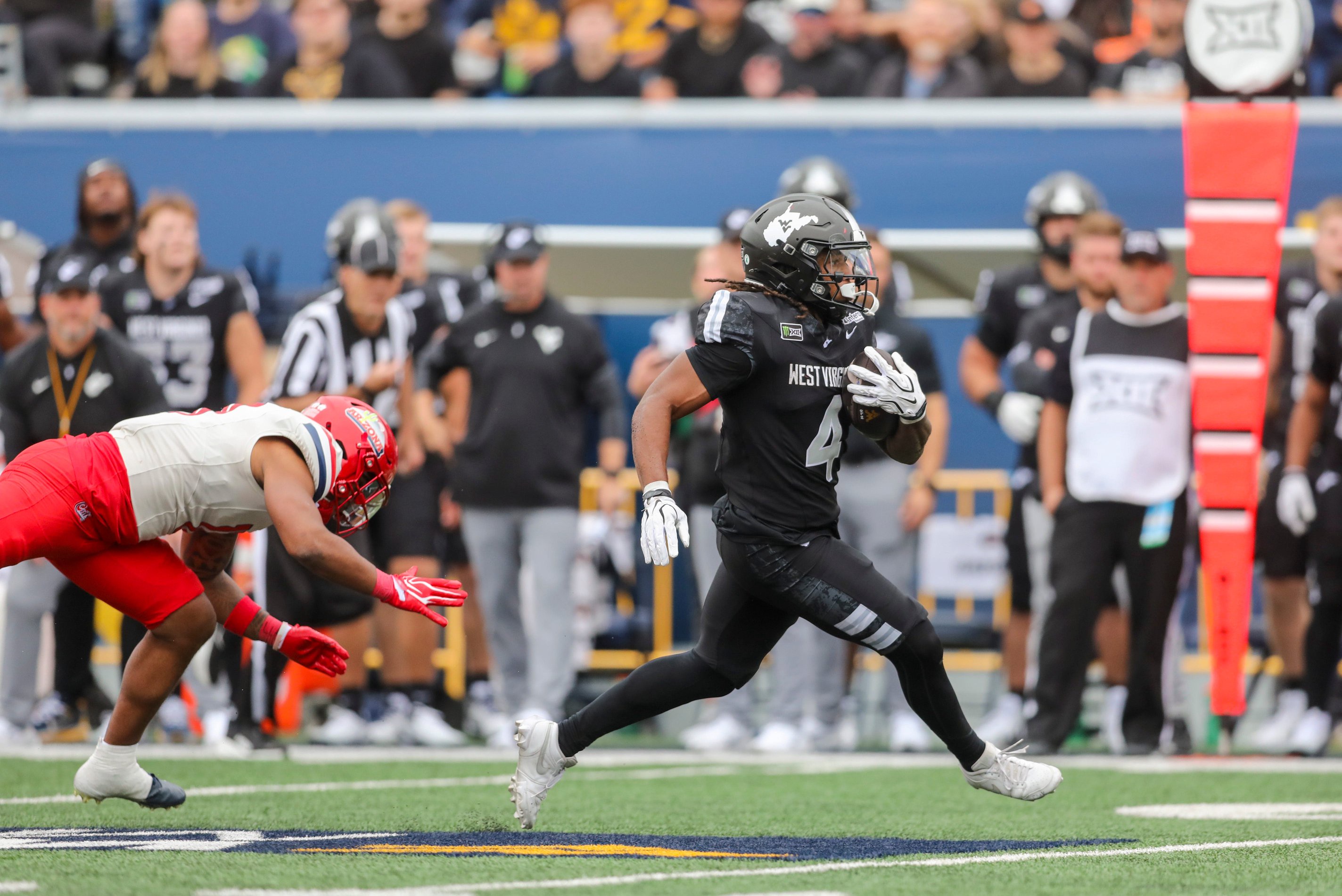 Oct 10, 2026; Morgantown, West Virginia, USA;  West Virginia Mountaineers running back Cam Cook (4) runs the ball for a touchdown during the second quarter against the Arizona Wildcats at Milan Puskar Stadium.  Mandatory Credit: Ben Queen-Imagn Images