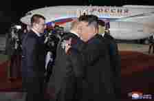 Russian President Vladimir Putin and North Korea’s leader Kim Jong Un, right, hug during the departure ceremony in  Pyongyang, North Korea