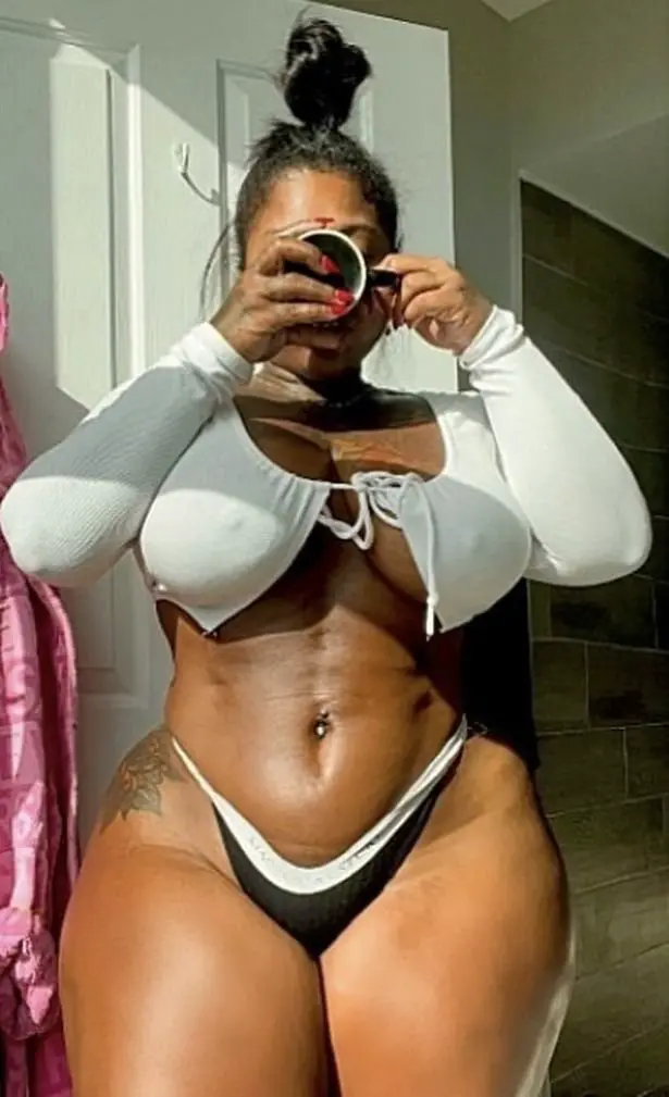 Rahki Giovanni poses for a photo in a crop top and bikini bottoms