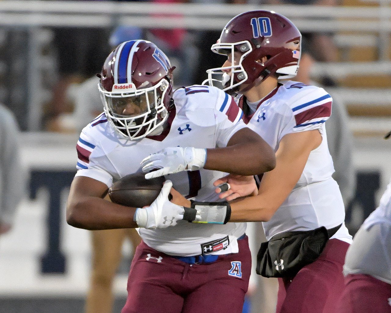 Annapolis Panthers quarterback Ayden Featherstone #10 hands off to Zhymarian Allen #17 in the first quarter. The Annapolis Panthers host the visiting Old Mill Patriots in a high school football held at Severna Park High School Friday evening. (Paul W. Gillespie/Staff)