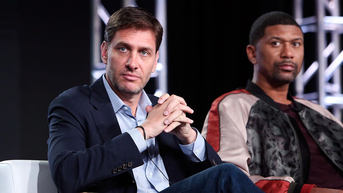 Mike Greenberg and Jalen Rose stand together at an event.