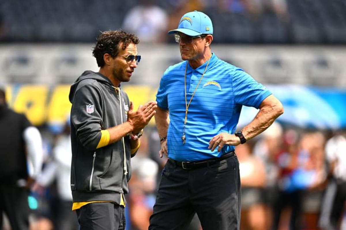 Los Angeles Chargers head coach Jim Harbaugh stands on the field with offensive coordinator Mike McDaniel prior to a game against the Arizona Cardinals at SoFi Stadium.at SoFi Stadium. (William Liang-Imagn Images)