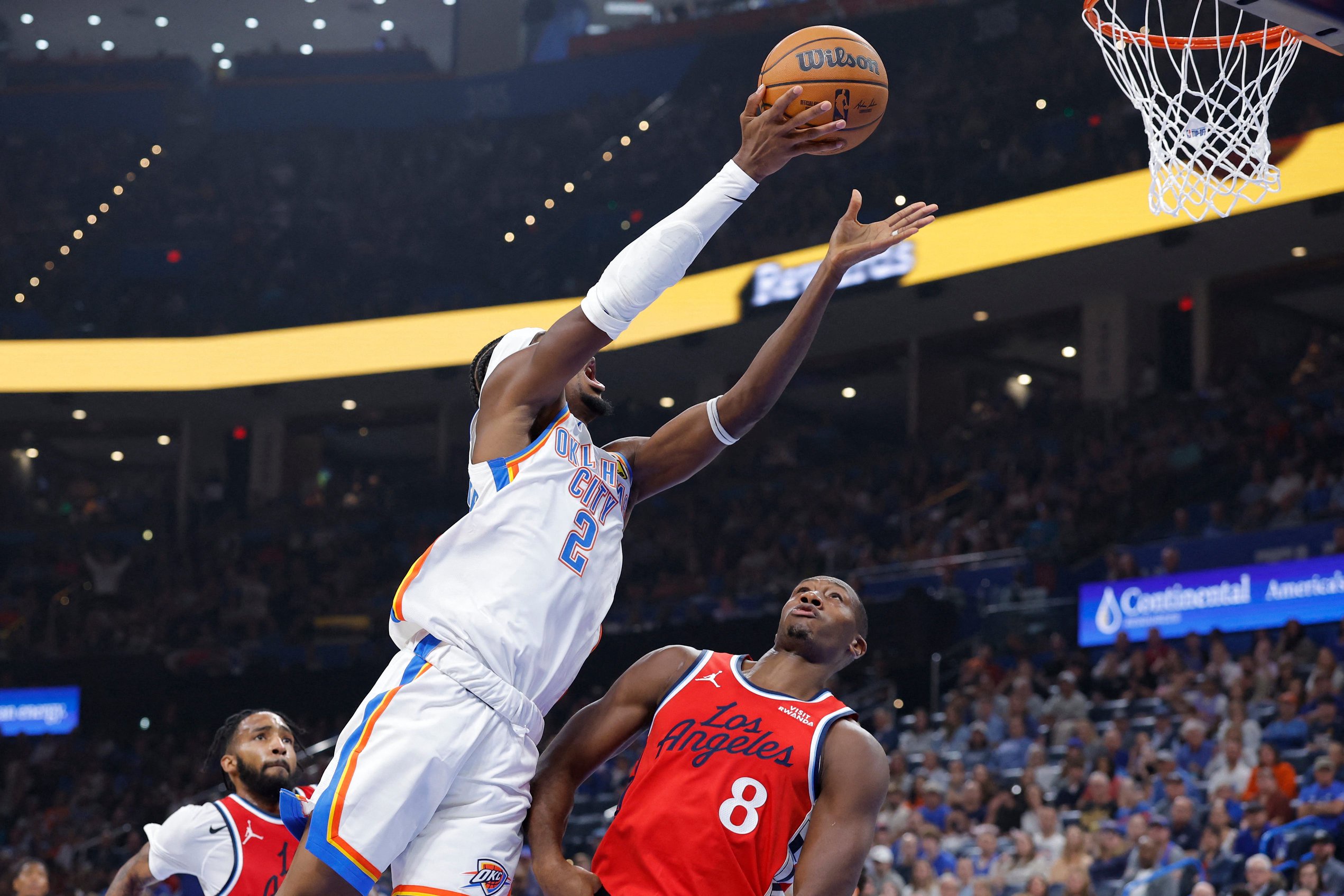 Oct 25, 2026; Oklahoma City, Oklahoma, USA; Oklahoma City Thunder guard Shai Gilgeous-Alexander (2) shoots over Los Angeles Clippers guard Kris Dunn (8) during the first half at Paycom Center. Mandatory Credit: Alonzo Adams-Imagn Images