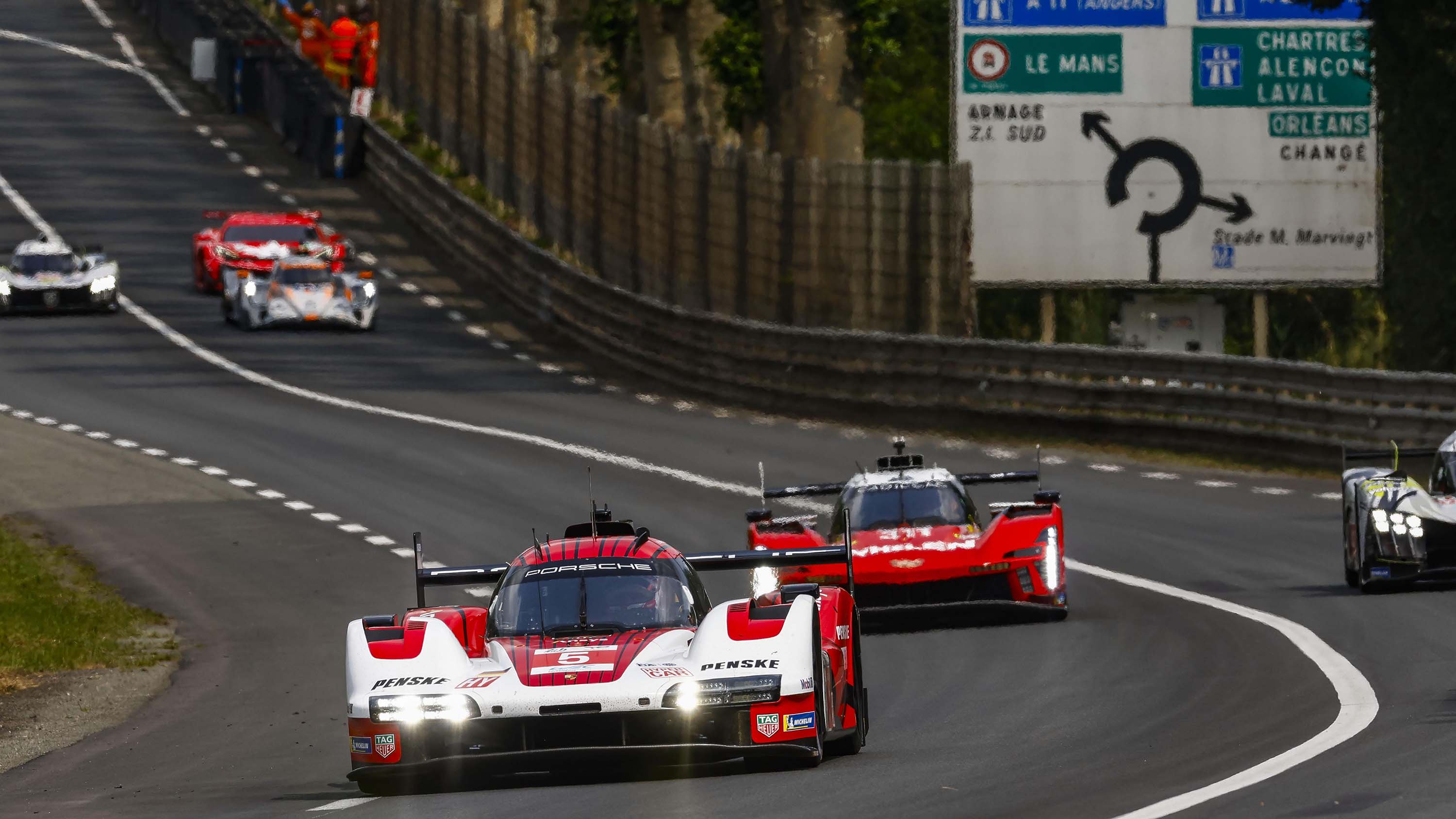 The No. 5 Porsche Penske 963 leads the Whelen Racing Cadillac during the 2025 24 Hours of Le Mans. With Porsche exiting, Cadillac could be the next partner for Team Penske to compete at Le Mans. 