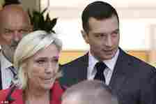 National Rally party president Jordan Bardella, right, leaves with leader Marine Le Pen after a press conference, Monday, June 24, 2024 in Paris