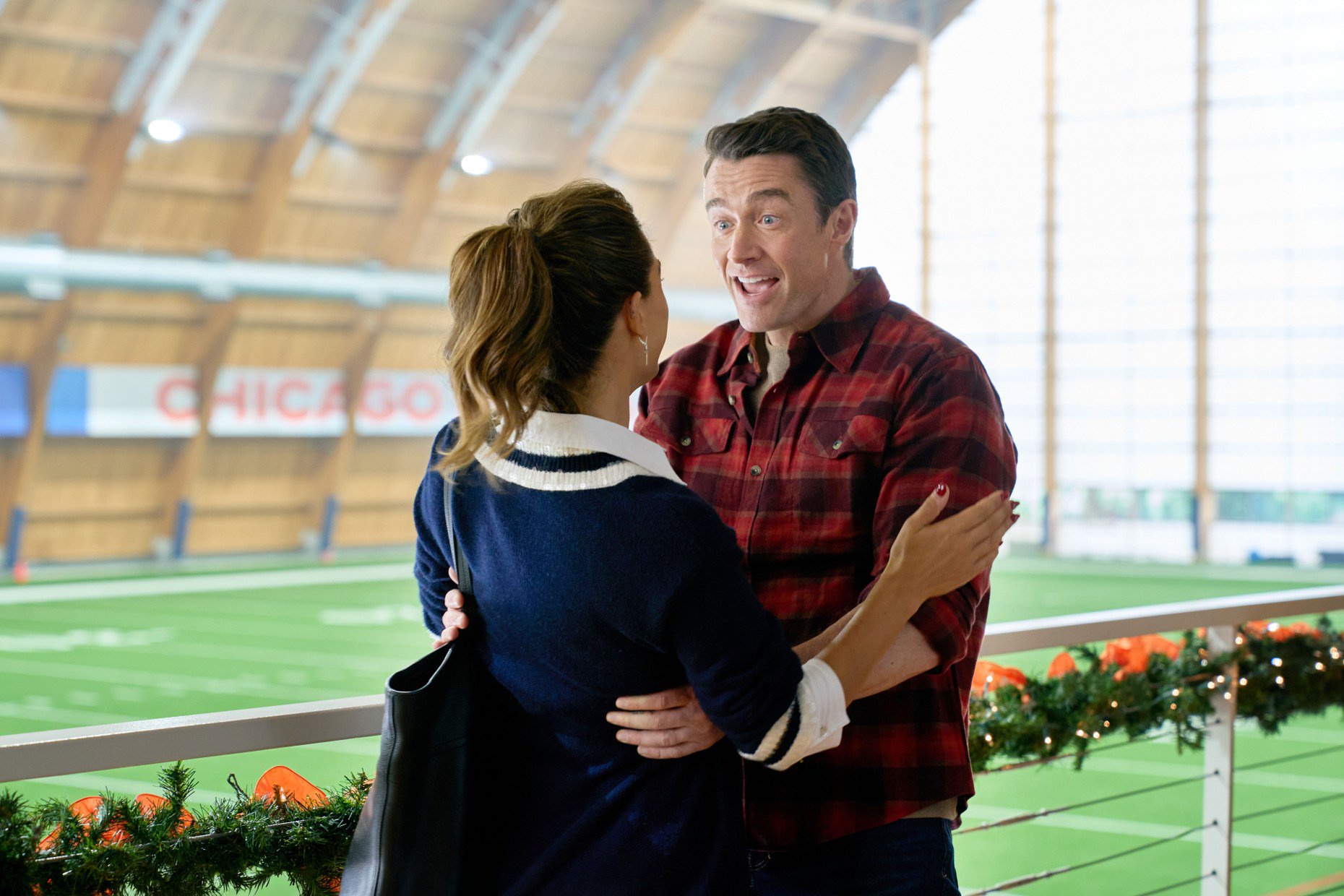 Avery (Lyndsy Fonseca) and Matt (Robert Buckley) at the Walter Payton Center in "Holiday Touchdown: A Bears Love Story." (Elizabeth Sisson/Hallmark Media)