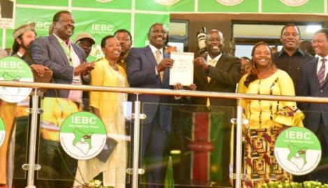 William Ruto on the left holding his certificate with Rigathi Gachagua on the right accompanied by other Kenya Kwanza leaders at Bomas of Kenya on August 15, 2022