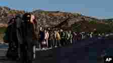 FILE - Chinese migrants wait to be processed after crossing the border with Mexico, May 8, 2024, near Jacumba Hot Springs, California.