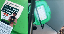 Close up of the sign on top of the green lid (left) and the smaller container attached (right).