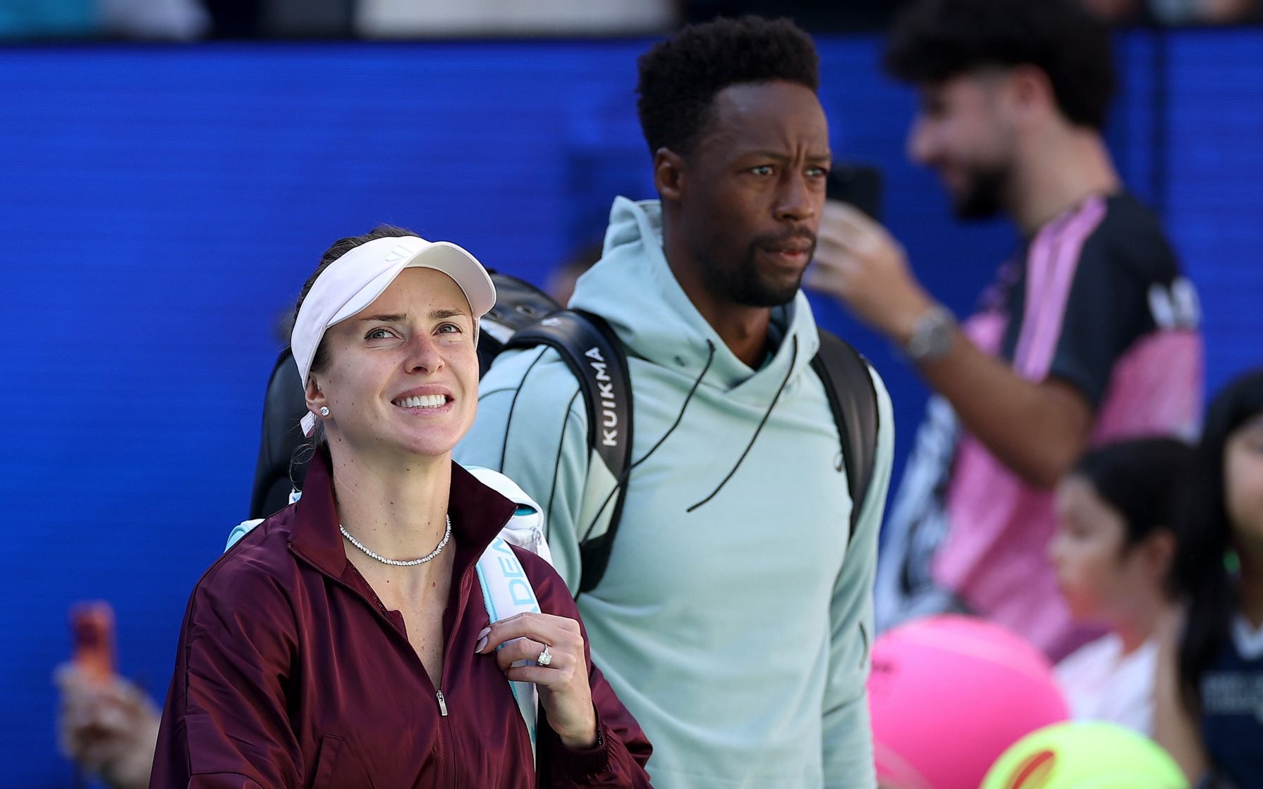 Gael Monfils of France walks out with Elina Svitolina of Ukraine in their mixed doubles