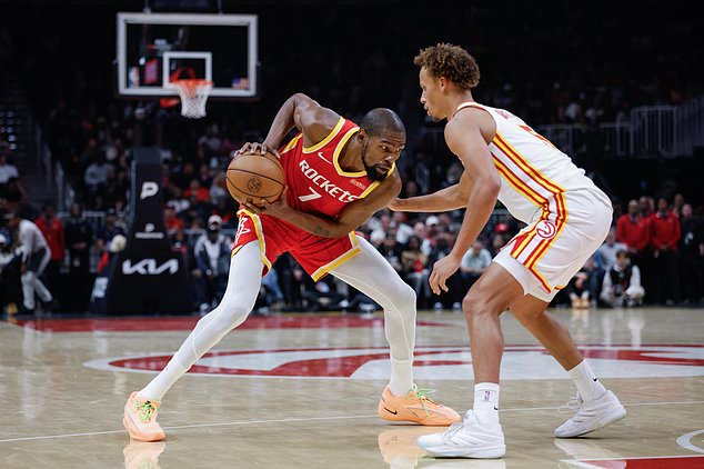 Houston Rockets forward Kevin Durant (7) drives against Atlanta Hawks guard Dyson Daniels, right, during the first half of an NBA basketball game, Saturday, Oct. 24, 2026, in Atlanta. (AP Photo/Erik S. Lesser)
