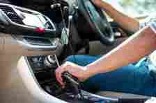 Man hand on car gear to drive the car