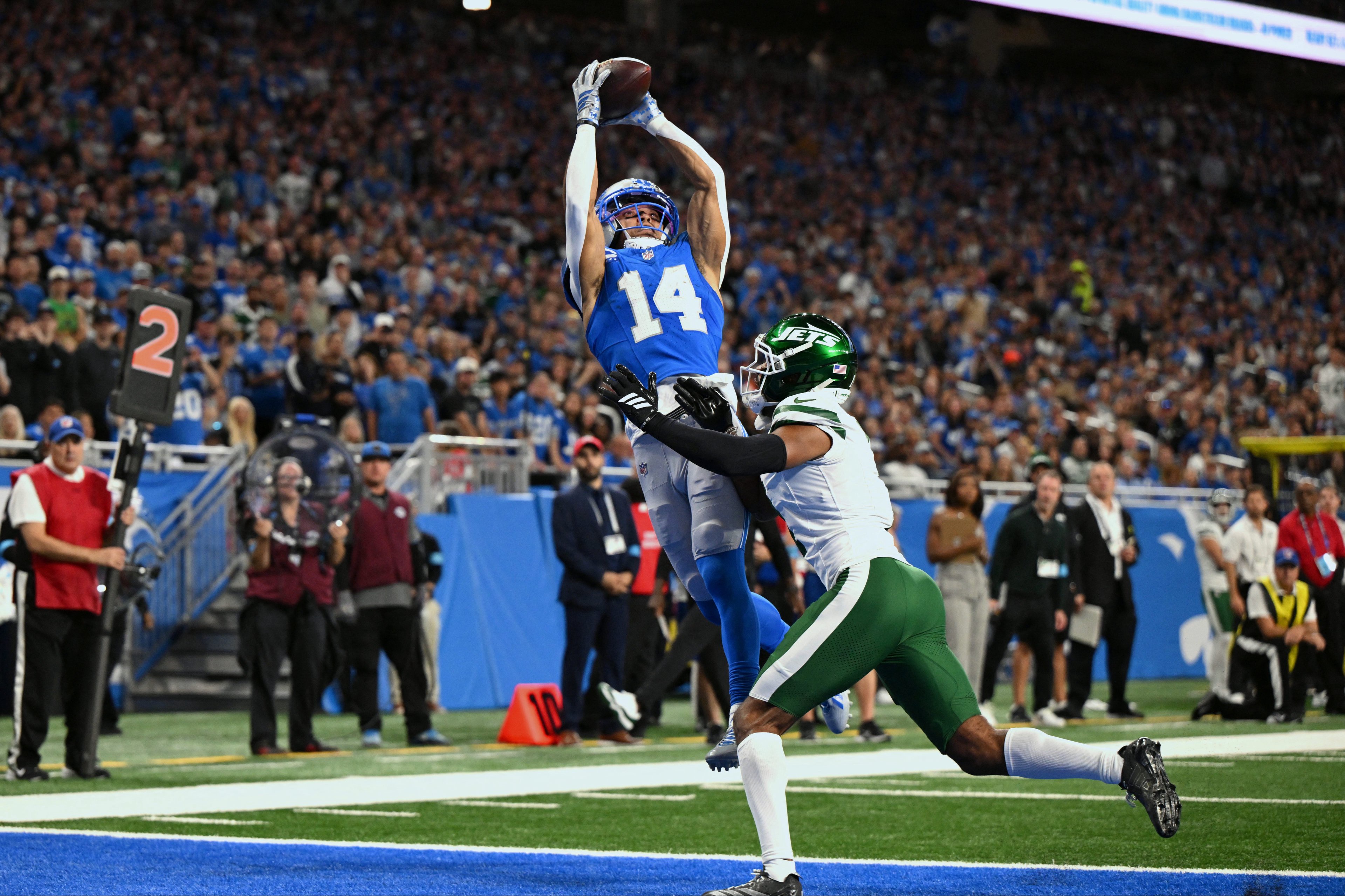 Sep 27, 2026; Detroit, Michigan, USA;  Detroit Lions wide receiver Amon-Ra St. Brown (14) catches a touchdown over New York Jets cornerback Azareye'h Thomas (1) during the second quarter at Ford Field.  Mandatory Credit: Lon Horwedel-Imagn Images