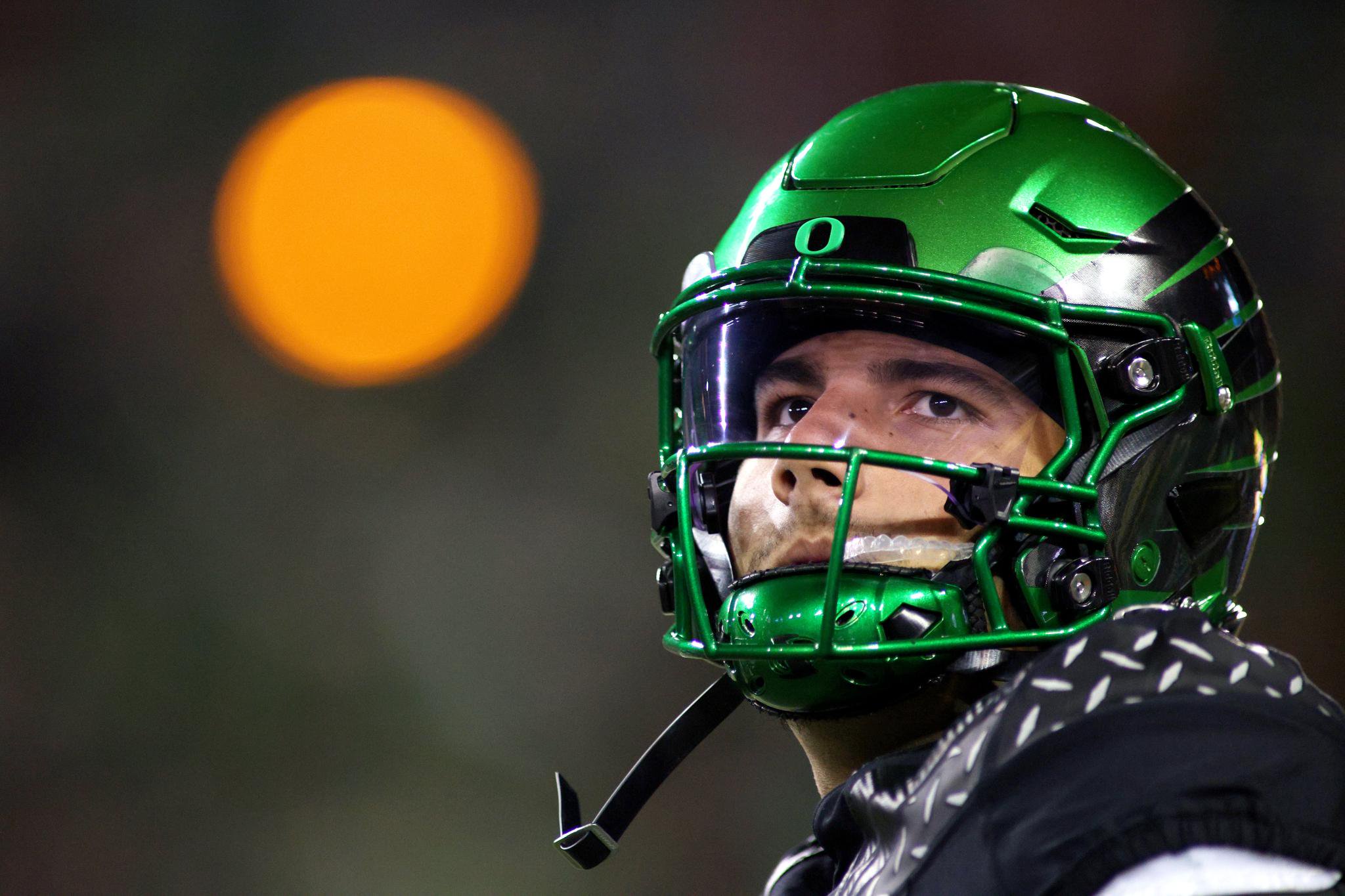 Dylan Raiola in a green Oregon helmet.