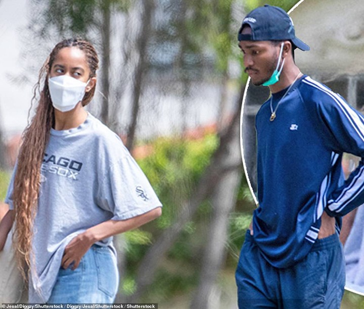 Meanwhile Sasha's boyfriend opted to keep his face mask down around his chin, and he wore a sporty look, pairing a long-sleeved navy shirt with a pair of matching sweatpants, white socks, and white striped slides.