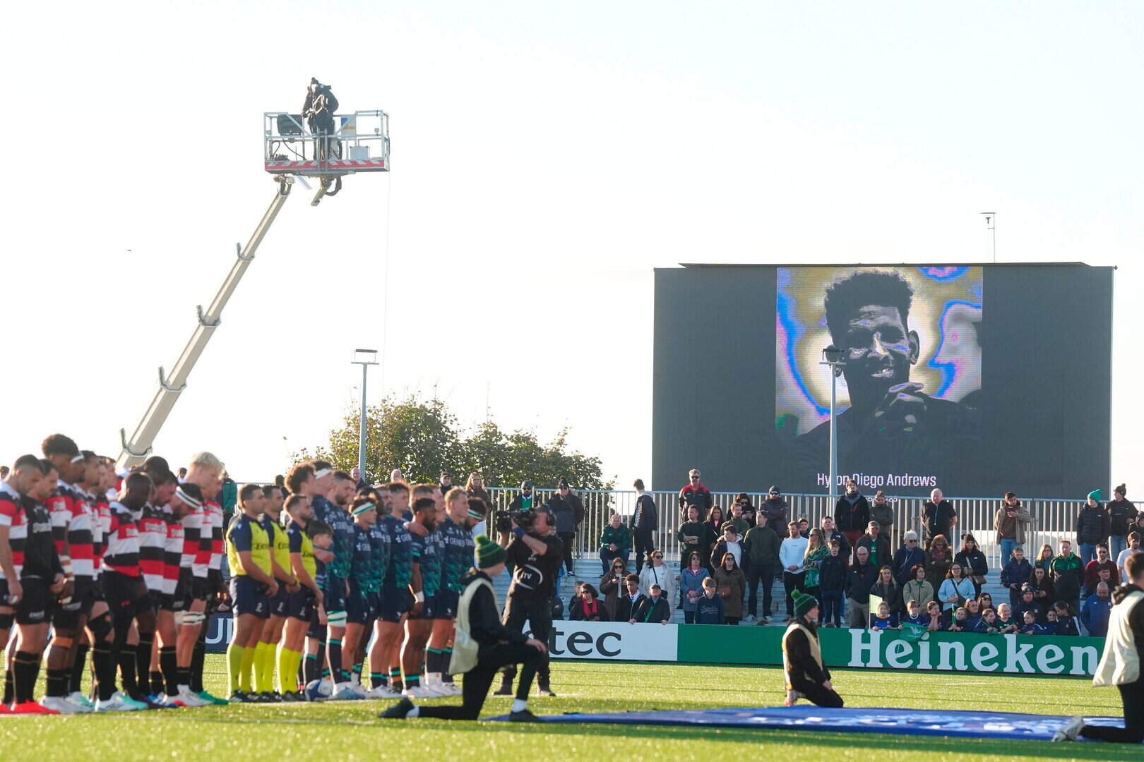 Connacht and Saracens players and fans during a minute's silence in memory of former Sale lock Hyron Andrews ahead of the Champions Cup match at the Dexcom Stadium in Galway