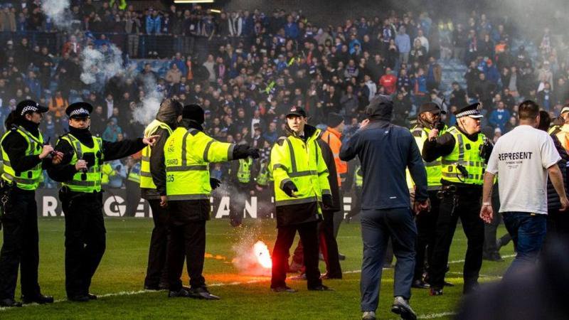 Fans from both sides ran on to the pitch at Ibrox in March
