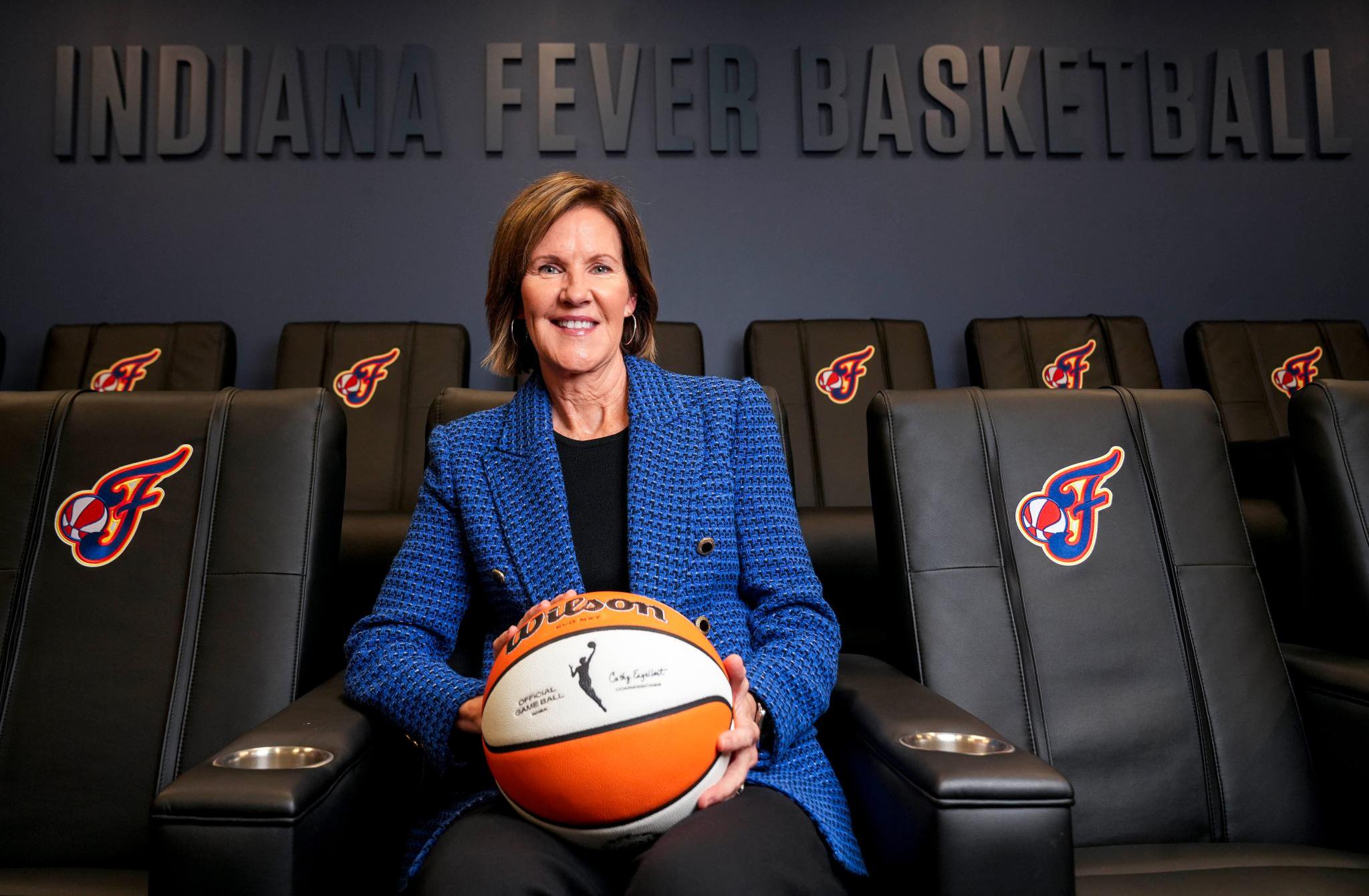 Kelly Krauskopf, president of the Indiana Fever, sits for a portrait holding a basketball at Gainbridge Fieldhouse in Indianapolis.