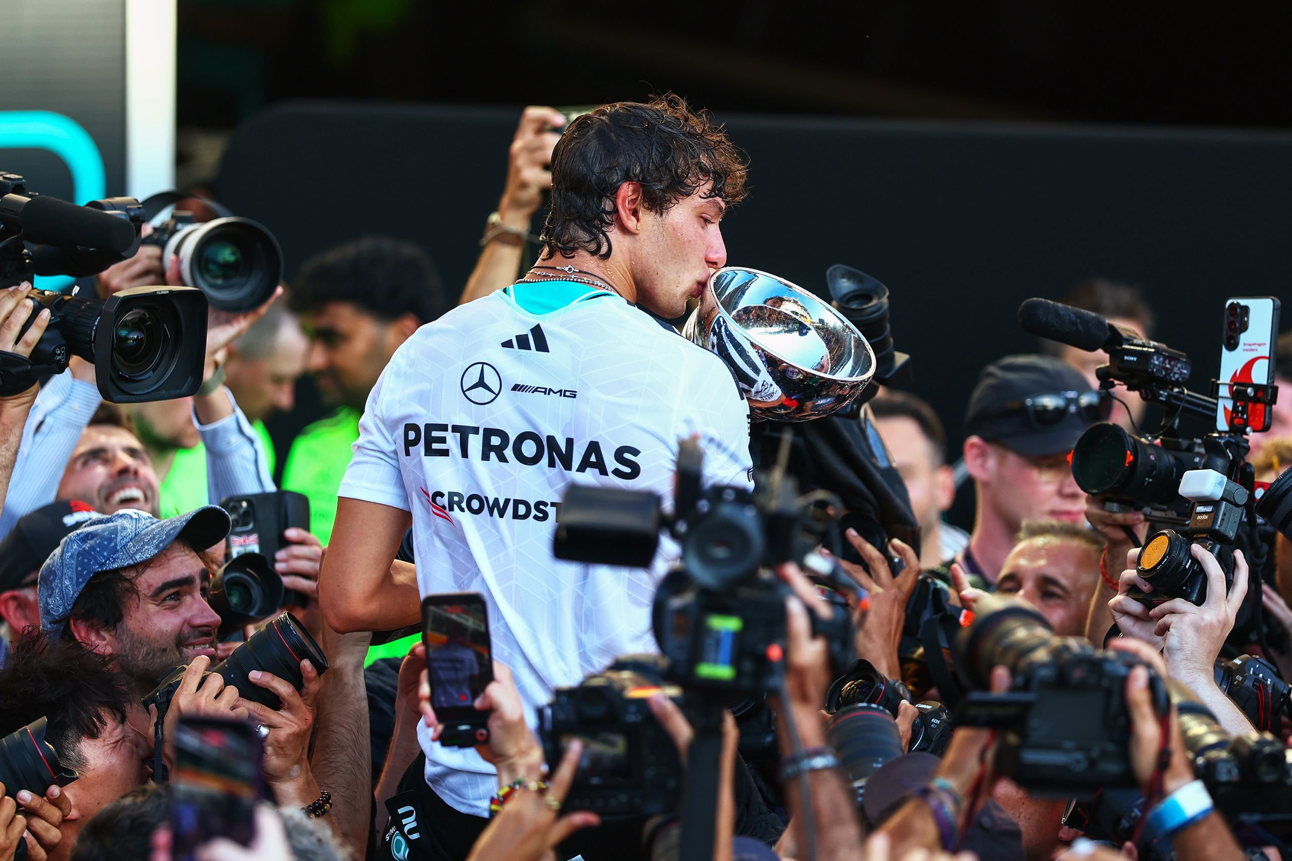 Kimi Antonelli kissing a trophy.